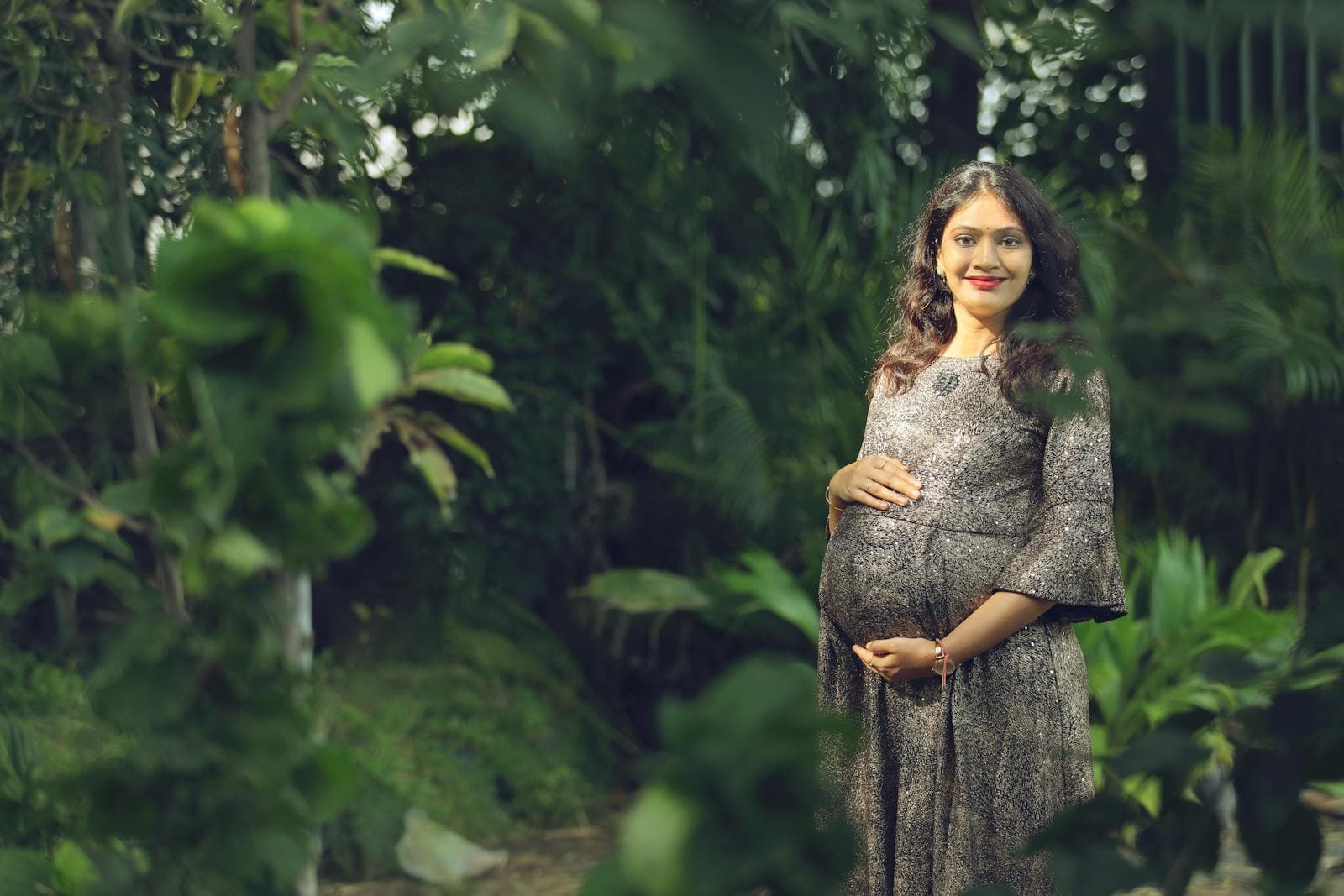 Pregnant woman in a garden, reflecting the reassurance of well-managed pregnancy care
